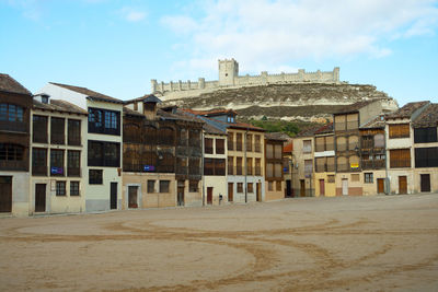 Buildings in town against sky