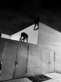 Low angle view of kids having fun and climbing a rooft on a fun jight