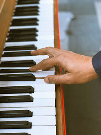 Cropped hand of person playing piano