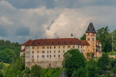 View of old building against cloudy sky