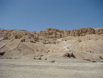 Scenic view of desert against clear blue sky