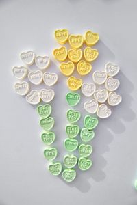 High angle view of candies on table against white background