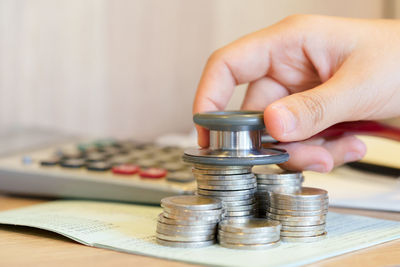 Close-up of hand holding coins