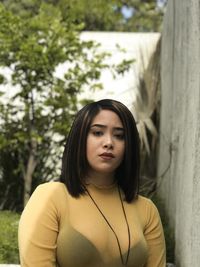 Portrait of beautiful young woman standing outdoors