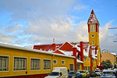 Yellow buildings against sky in city