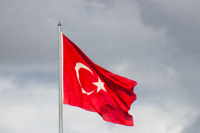Low angle view of flag against sky