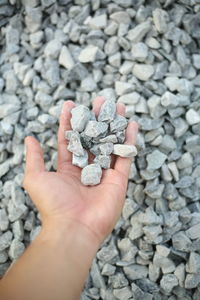 Close-up of hand holding pebbles