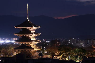 Illuminated pagoda in city at night