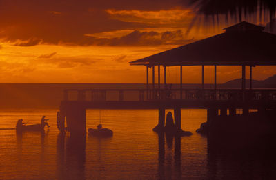 Scenic view of pier on beach during sunset