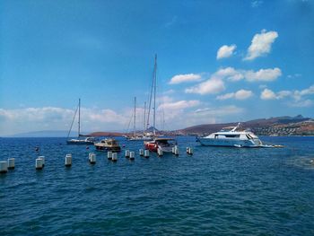 Sailboats in sea against sky