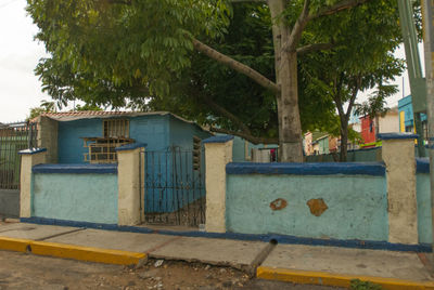 Built structure by trees against the wall