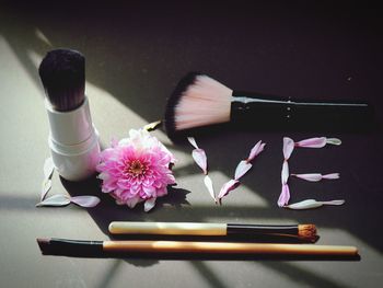 High angle view of beauty products and flower
