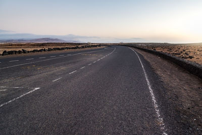 Road passing through landscape against sky