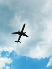 Low angle view of airplane against sky