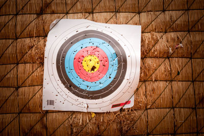 Close-up of dartboard on straw wall