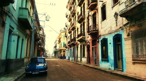 Vehicles on road along buildings