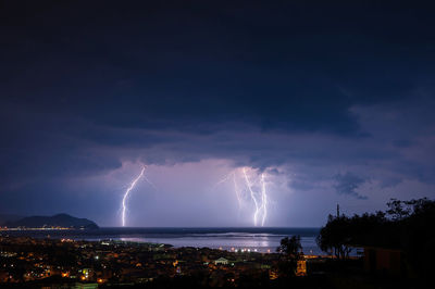 Lightening strikes town near coast at night