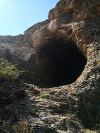 Low angle view of rock formation against sky