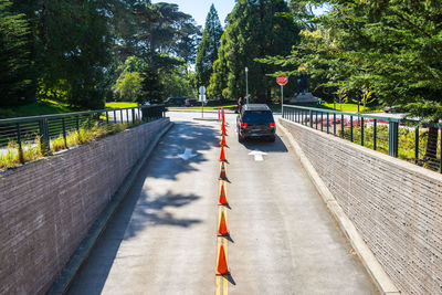 Road by bridge against trees