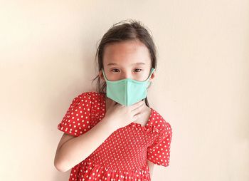 Portrait of girl against wall