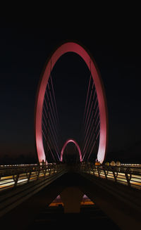 View of bridge over road at night