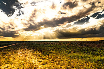 Scenic view of landscape against cloudy sky