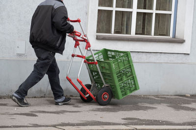 Man working on street against building