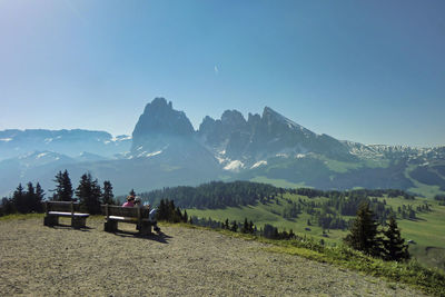 Scenic view of field against mountain range against clear sky