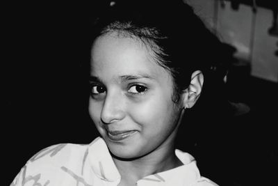 Close-up portrait of smiling girl at home