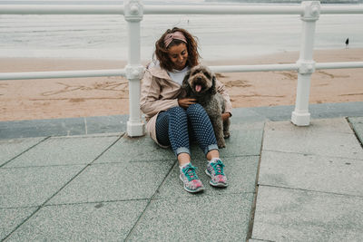 Happy woman with dog at beach