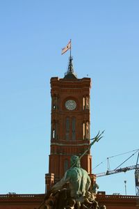 Low angle view of statue against clear blue sky