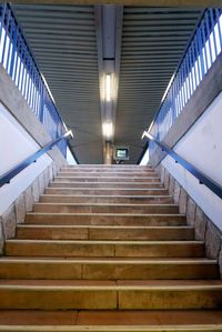 Low angle view of steps leading towards illuminated railroad station platform