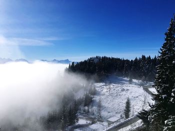 Snow covered landscape against sky