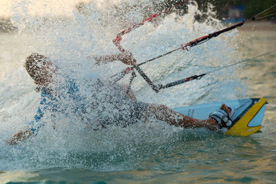 Man wakeboarding in sea against sky