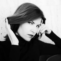 Portrait of confident woman with hand in hair