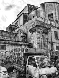 Old abandoned building against sky in city