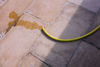 High angle view of yellow shadow on footpath