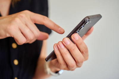 Midsection of man using mobile phone