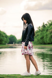 Full length of woman standing in lake