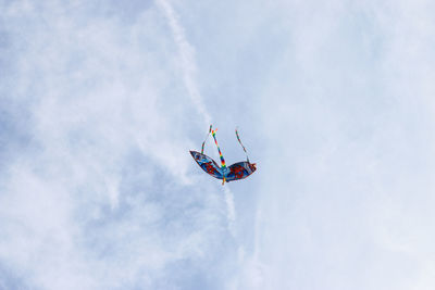 Low angle view of kite flying against sky