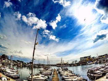 Harbor against cloudy sky