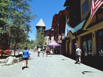 People walking in front of built structure