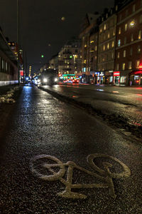 View of city street and buildings at night