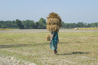 Full length of woman walking on field