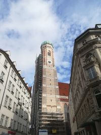 Low angle view of buildings against cloudy sky