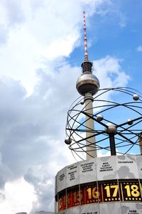 Low angle view of fernsehturm tower against cloudy sky