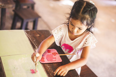 Close-up of cute girl making artwork at workshop