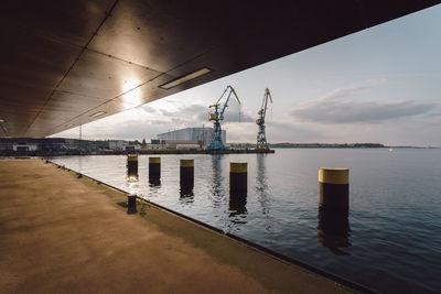 Commercial dock by sea against sky