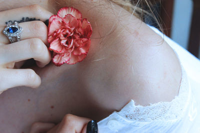 Close-up of woman hand with flowers