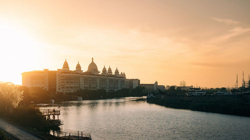 Bridge over river against sky during sunset